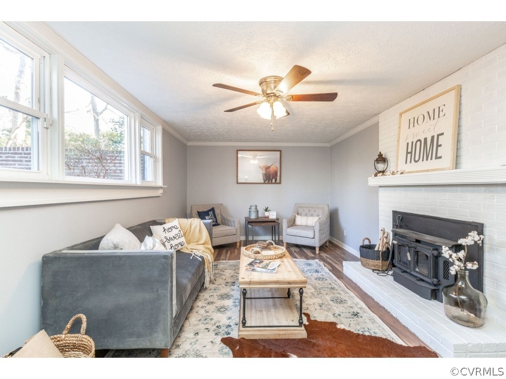 8541 Elm Road Richmond, VA 23235 - Photo 36 of 50 a living room with furniture and a fireplace