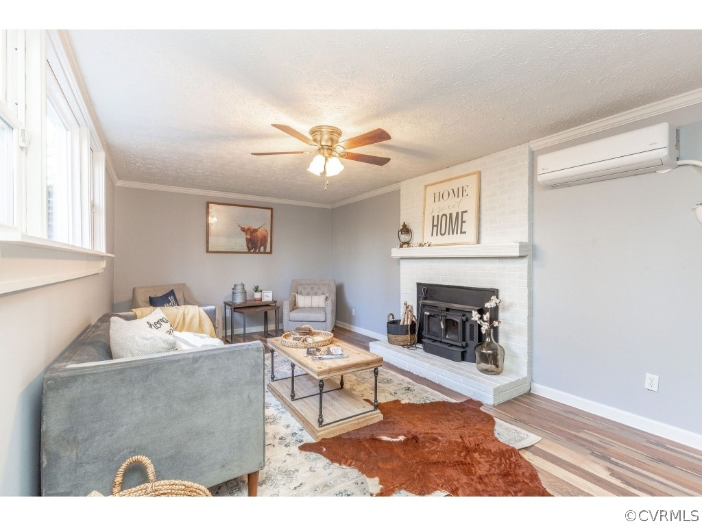 8541 Elm Road Richmond, VA 23235 - Photo 37 of 50 a living room with furniture and a fireplace