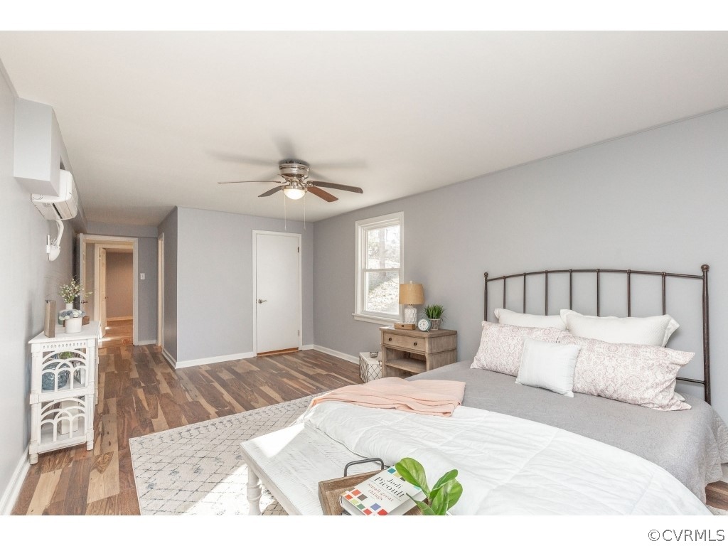 8541 Elm Road Richmond, VA 23235 - Photo 42 of 50 a bedroom with a large bed and a chandelier