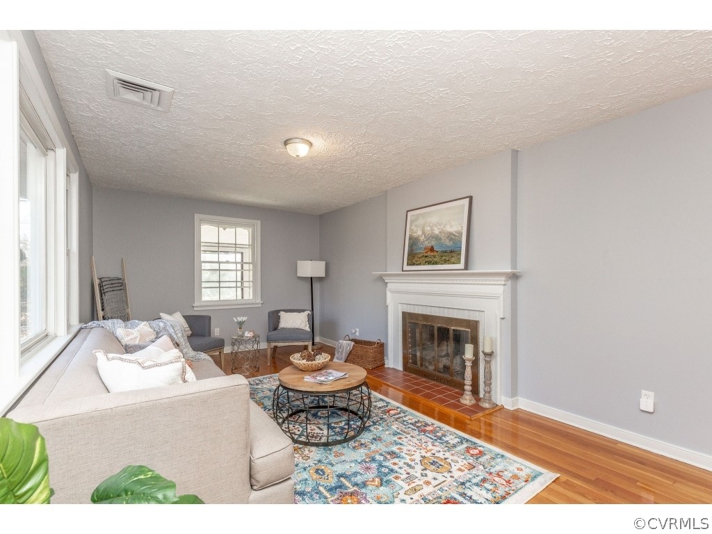 8541 Elm Road Richmond, VA 23235 - Photo 9 of 50 a living room with furniture a window and a fireplace
