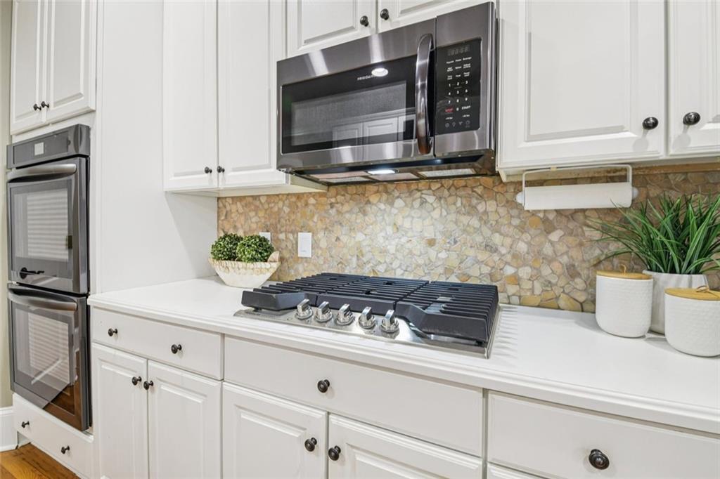 121 Fulton Way Southeast Atlanta, GA 30312 - Photo 16 of 38 a kitchen with stainless steel appliances a white stove top oven and cabinets
