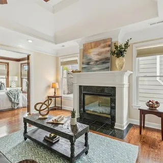 a living room with furniture a table and a fireplace