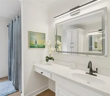 a bathroom with a sink a toilet and shower curtain