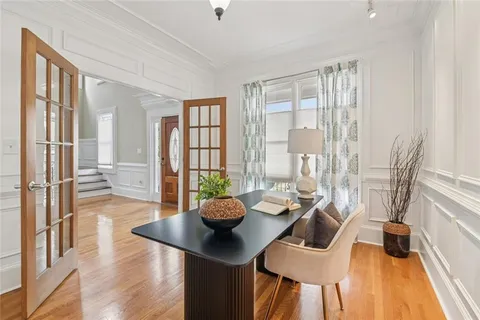 a view of a dining room with furniture and wooden floor