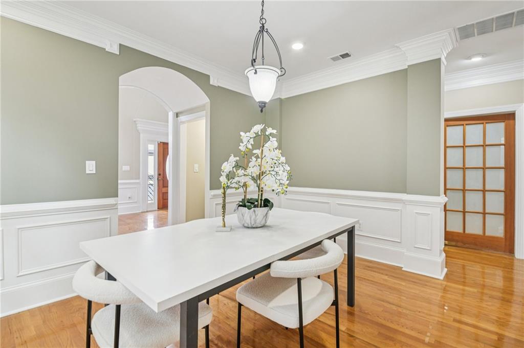 121 Fulton Way Southeast Atlanta, GA 30312 - Photo 10 of 38 a dining room with wooden floor a chandelier a wooden table and chairs