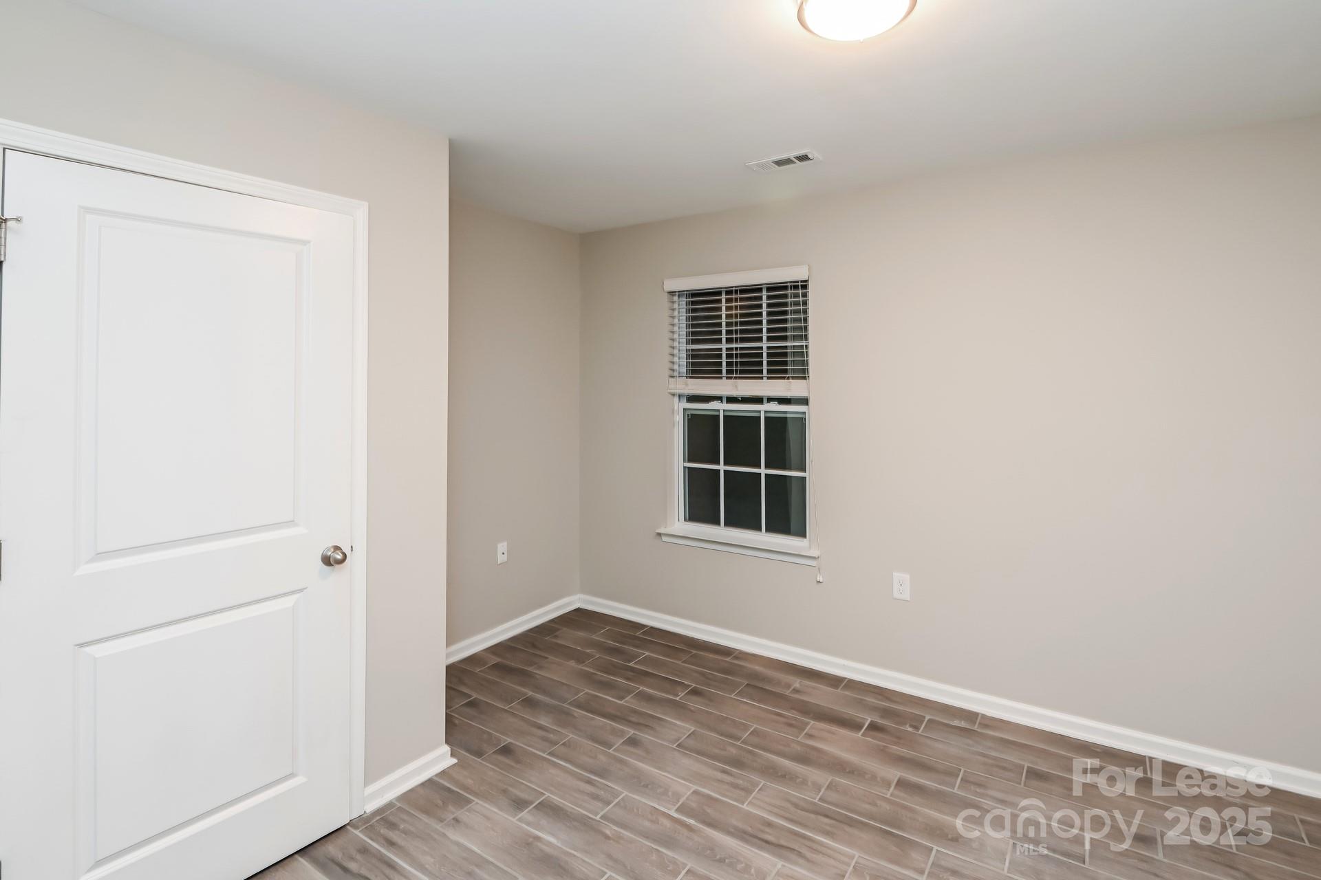 4123 Long Arrow Drive Concord, NC 28025 - Photo 11 of 17 a view of an empty room with wooden floor and a window