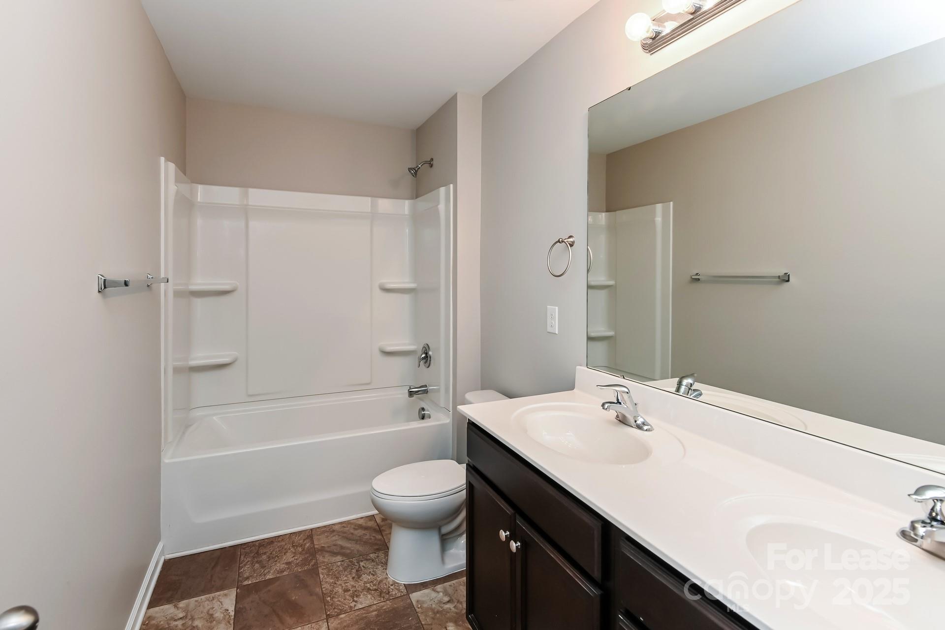 4123 Long Arrow Drive Concord, NC 28025 - Photo 13 of 17 a bathroom with a sink a toilet and shower