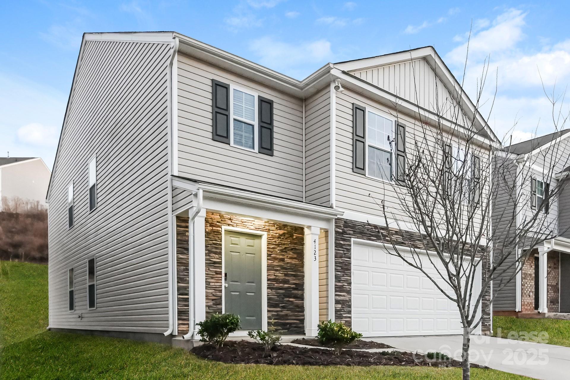 4123 Long Arrow Drive Concord, NC 28025 - Photo 2 of 17 a front view of a house with garden
