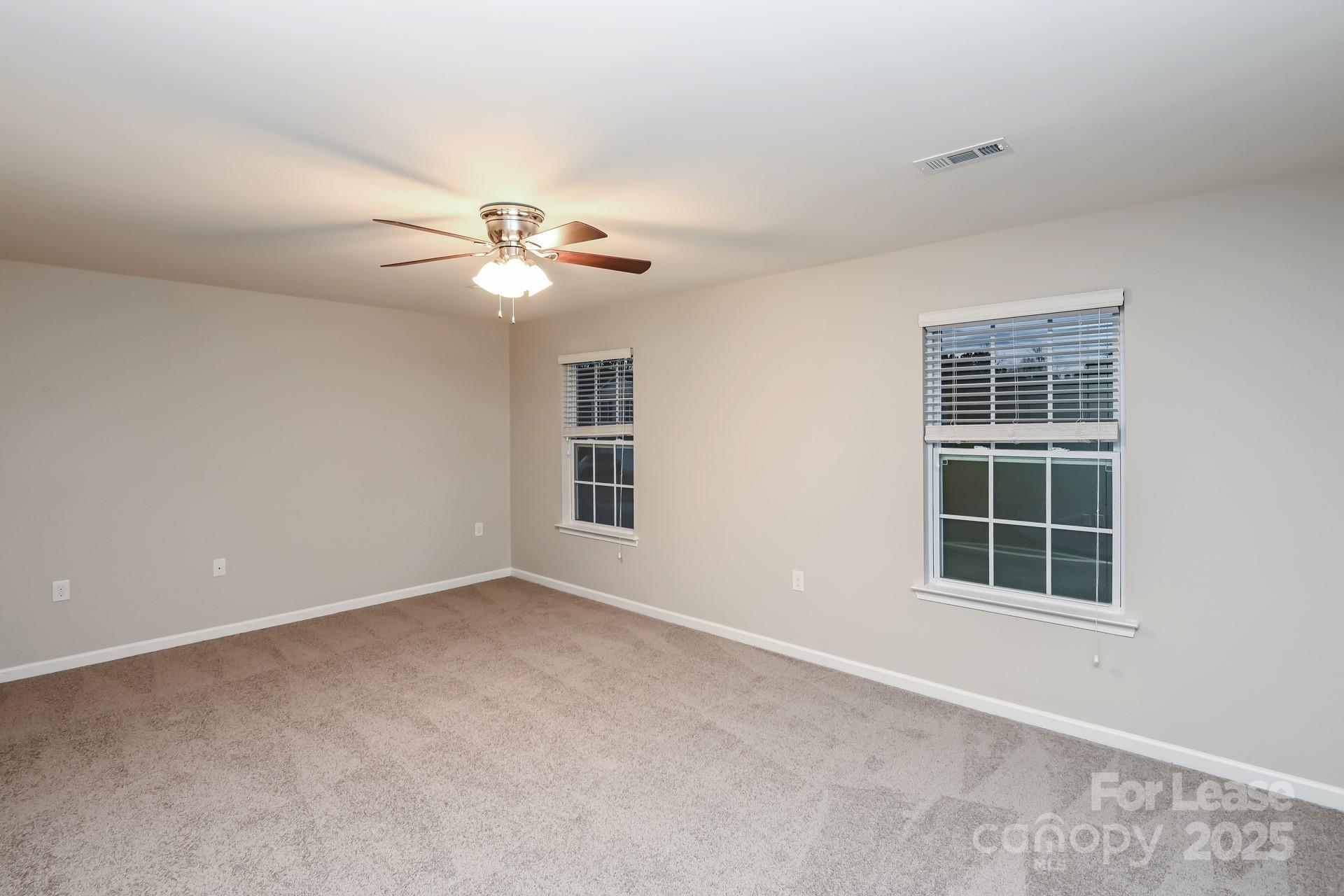 4123 Long Arrow Drive Concord, NC 28025 - Photo 7 of 17 an empty room with window and ceiling fan