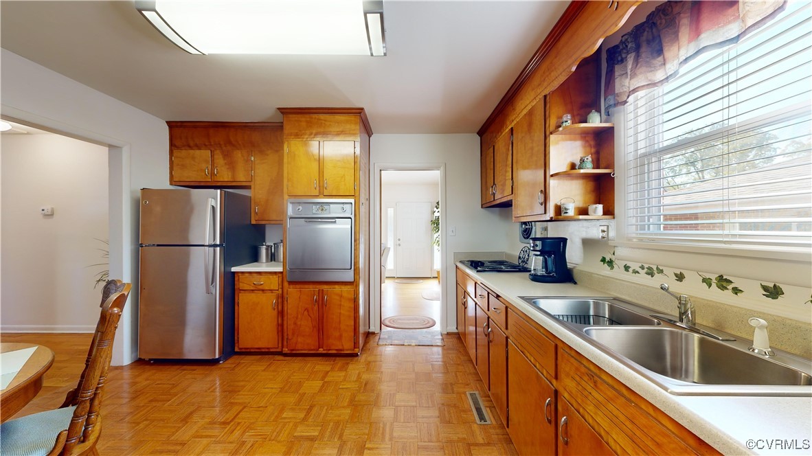 706 James Avenue Colonial Heights, VA 23834 - Photo 9 of 14 a kitchen with stainless steel appliances granite countertop a refrigerator a stove a sink a washer and dryer