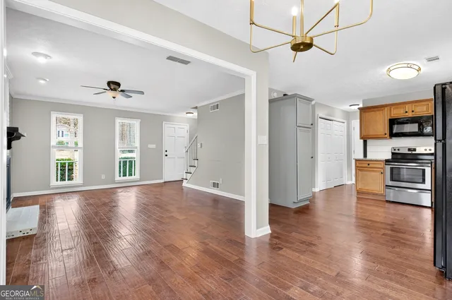 a kitchen with a refrigerator a stove top oven a sink and dishwasher