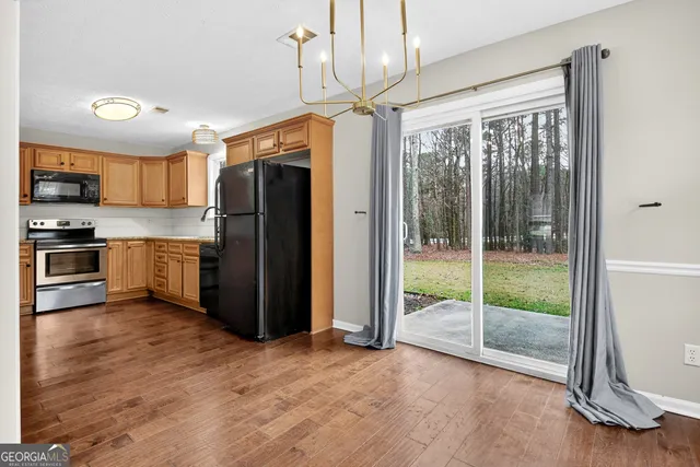 a kitchen with granite countertop a refrigerator and a sink