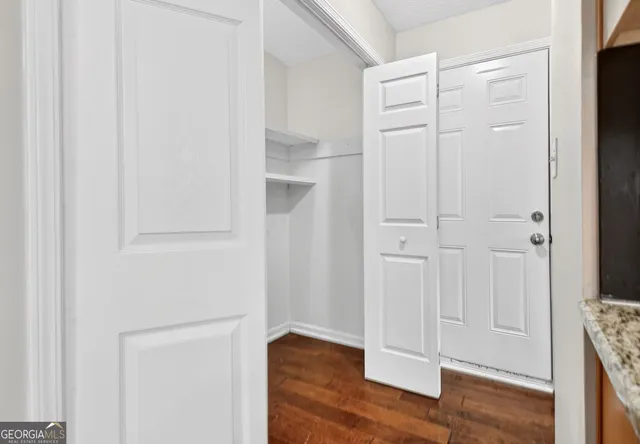 a view of a room with wooden floor