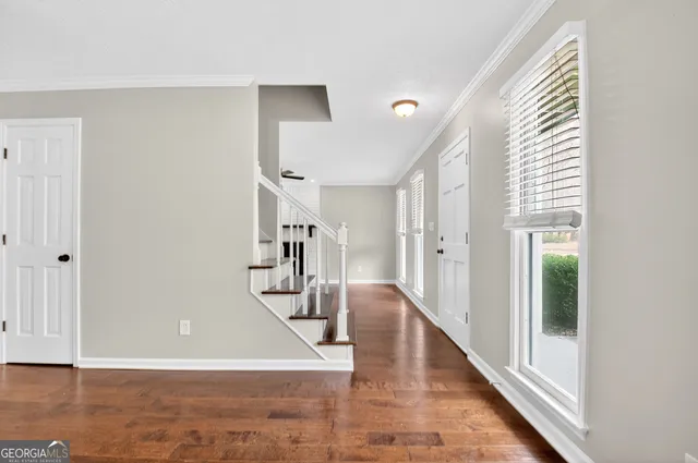a view of a room with wooden floor