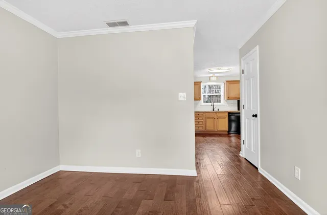 an empty room with windows and flowerpot
