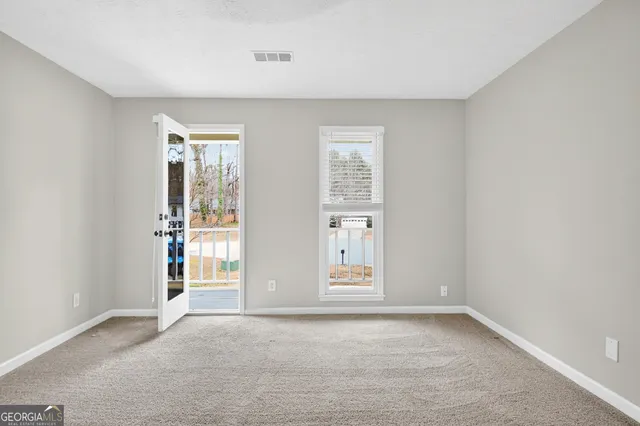 a bathroom with a granite countertop sink a mirror and a shower