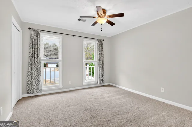 a spacious bedroom with a bed and a large window