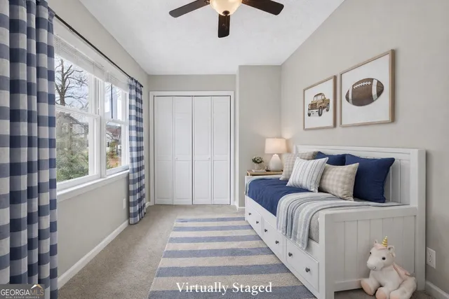 an empty room with a window and a ceiling fan
