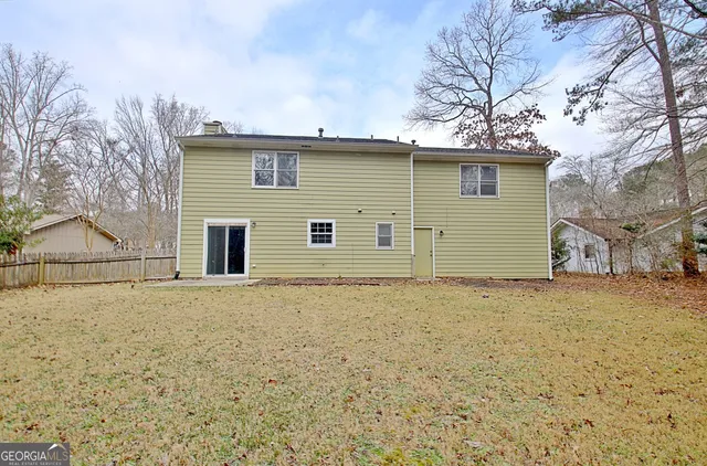 an aerial view of a house with a garden and lake view