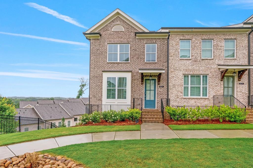 a front view of a house with a yard