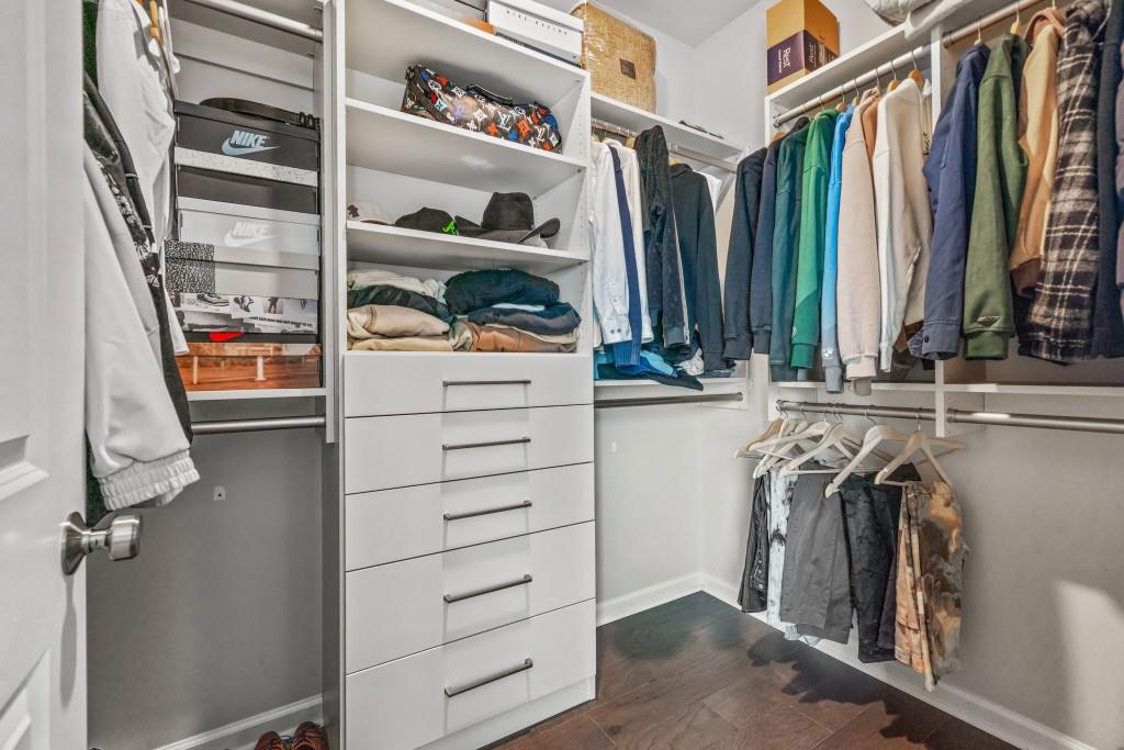5217 Riden Court, Unit 263 Buford, GA 30518 - Photo 21 of 34 a view of walk in closet with clothes and shoes