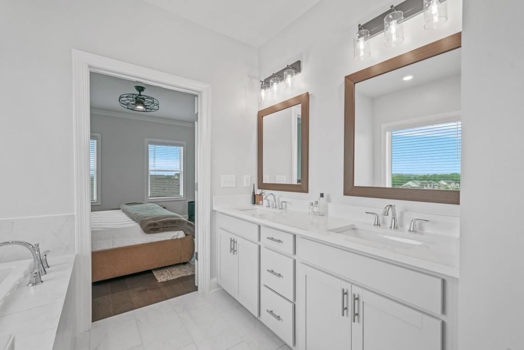5217 Riden Court, Unit 263 Buford, GA 30518 - Photo 24 of 34 a en suite bathroom with double sink and a mirror