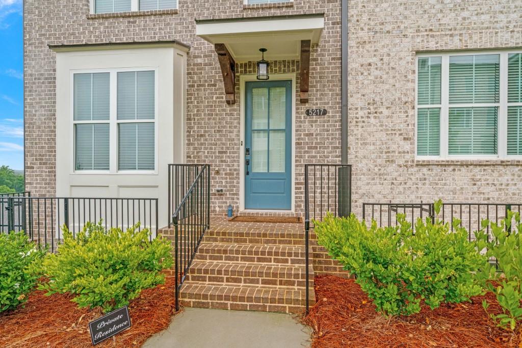 5217 Riden Court, Unit 263 Buford, GA 30518 - Photo 3 of 34 a front view of a house with a garden