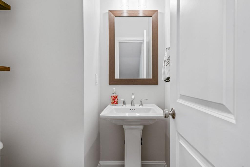 5217 Riden Court, Unit 263 Buford, GA 30518 - Photo 31 of 34 a bathroom with a sink and a mirror