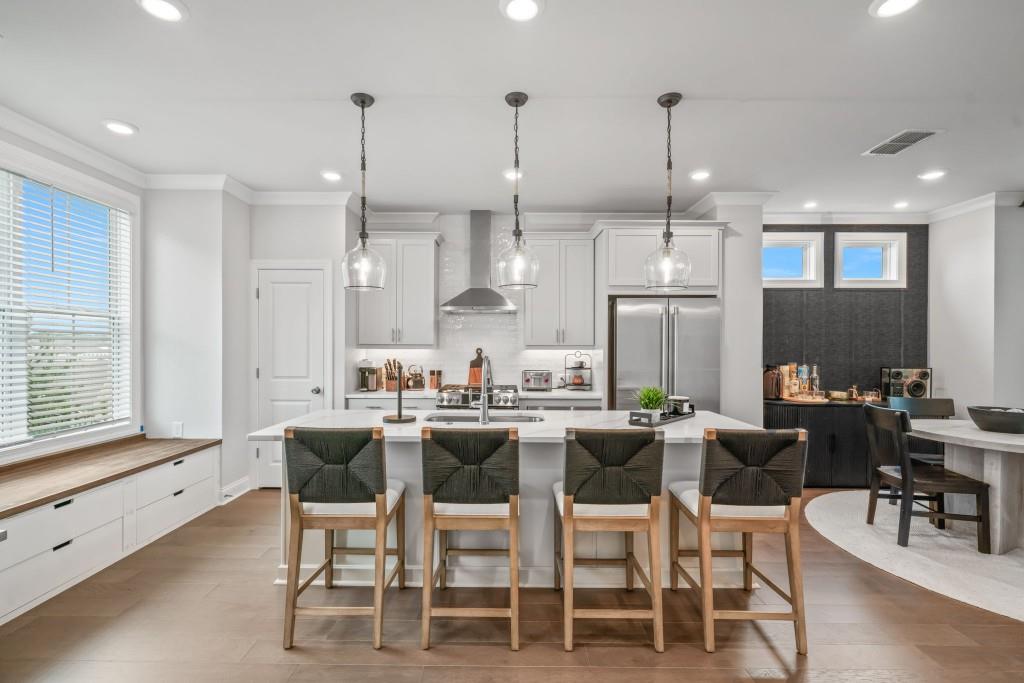 5217 Riden Court, Unit 263 Buford, GA 30518 - Photo 7 of 34 a dining room with stainless steel appliances kitchen island granite countertop a dining table chairs and a refrigerator