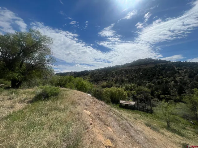 a kitchen with red and white wall under a large mirror