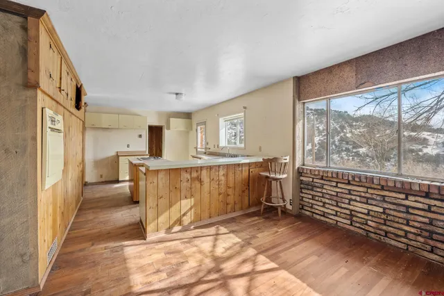 a view of a hallway with furniture and staircase
