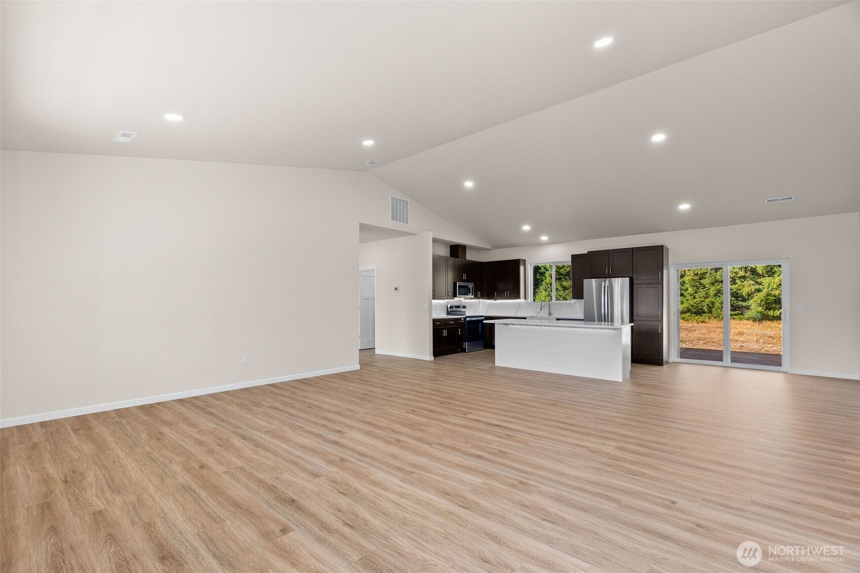 6123 186th Trail Southwest Rochester, WA 98579 - Photo 4 of 35 a view of kitchen with kitchen island wooden floor and center island