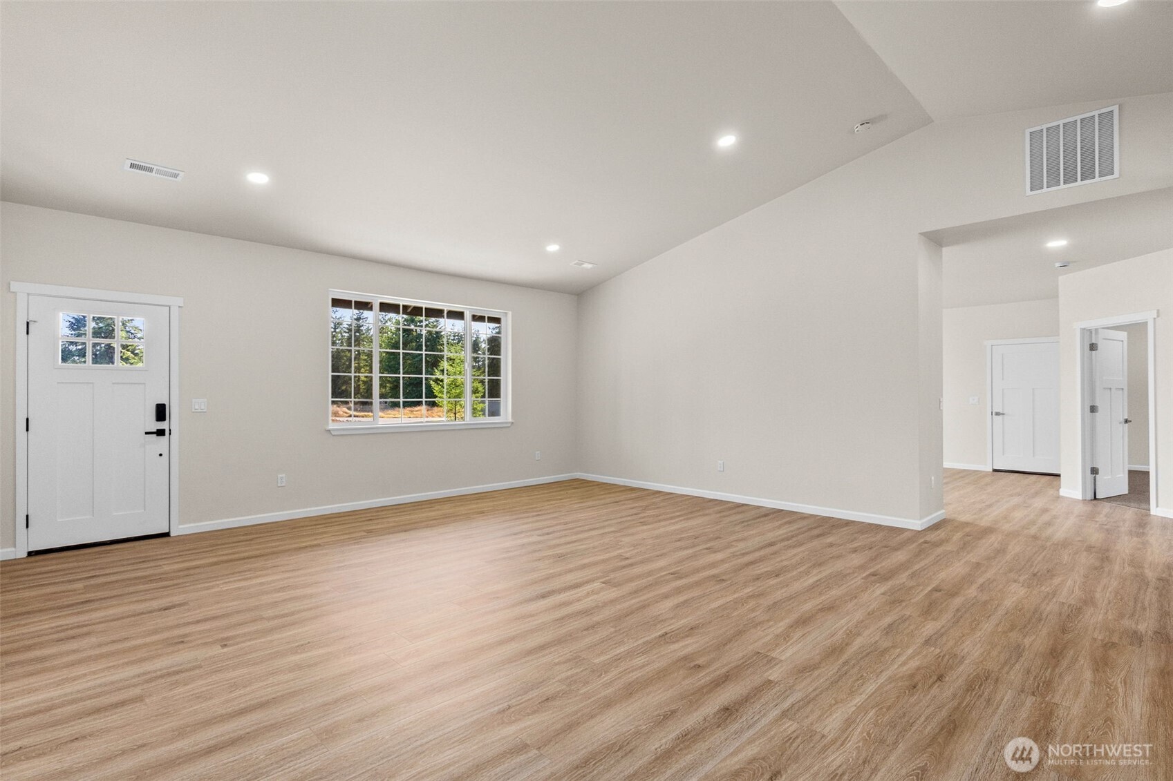 6123 186th Trail Southwest Rochester, WA 98579 - Photo 6 of 35 a view of an empty room with wooden floor and a window