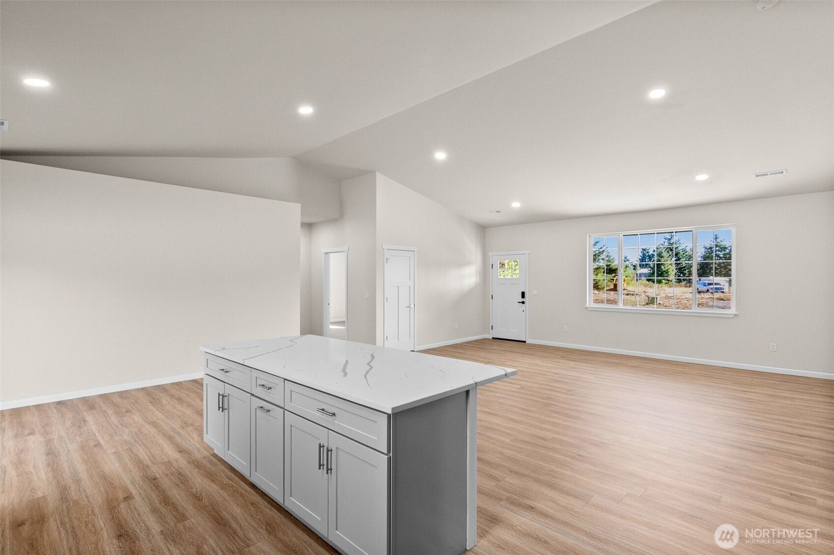 6123 186th Trail Southwest Rochester, WA 98579 - Photo 7 of 35 a view of an empty room with wooden floor and a window