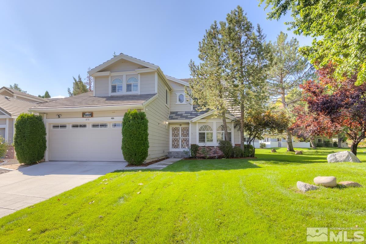 a view of a house with a big yard and large trees