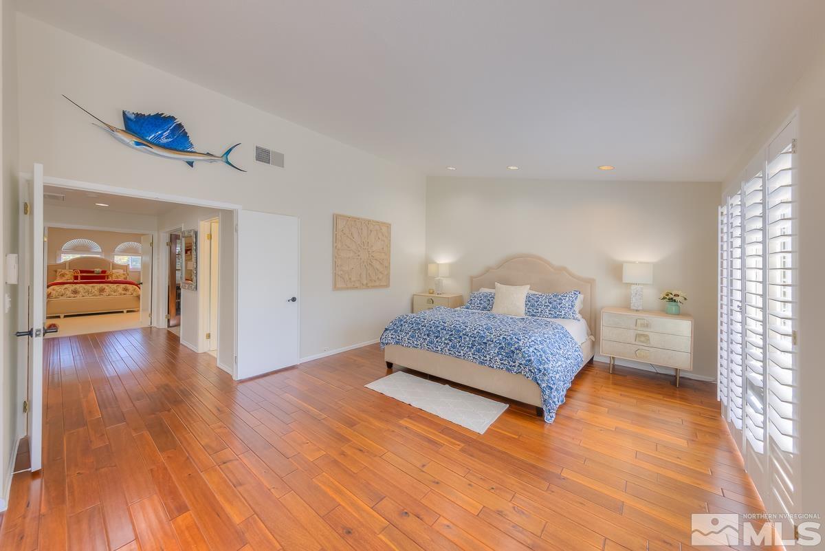 858 Lighthouse Court Reno, NV 89511 - Photo 17 of 39 a bedroom with a bed and wooden floor