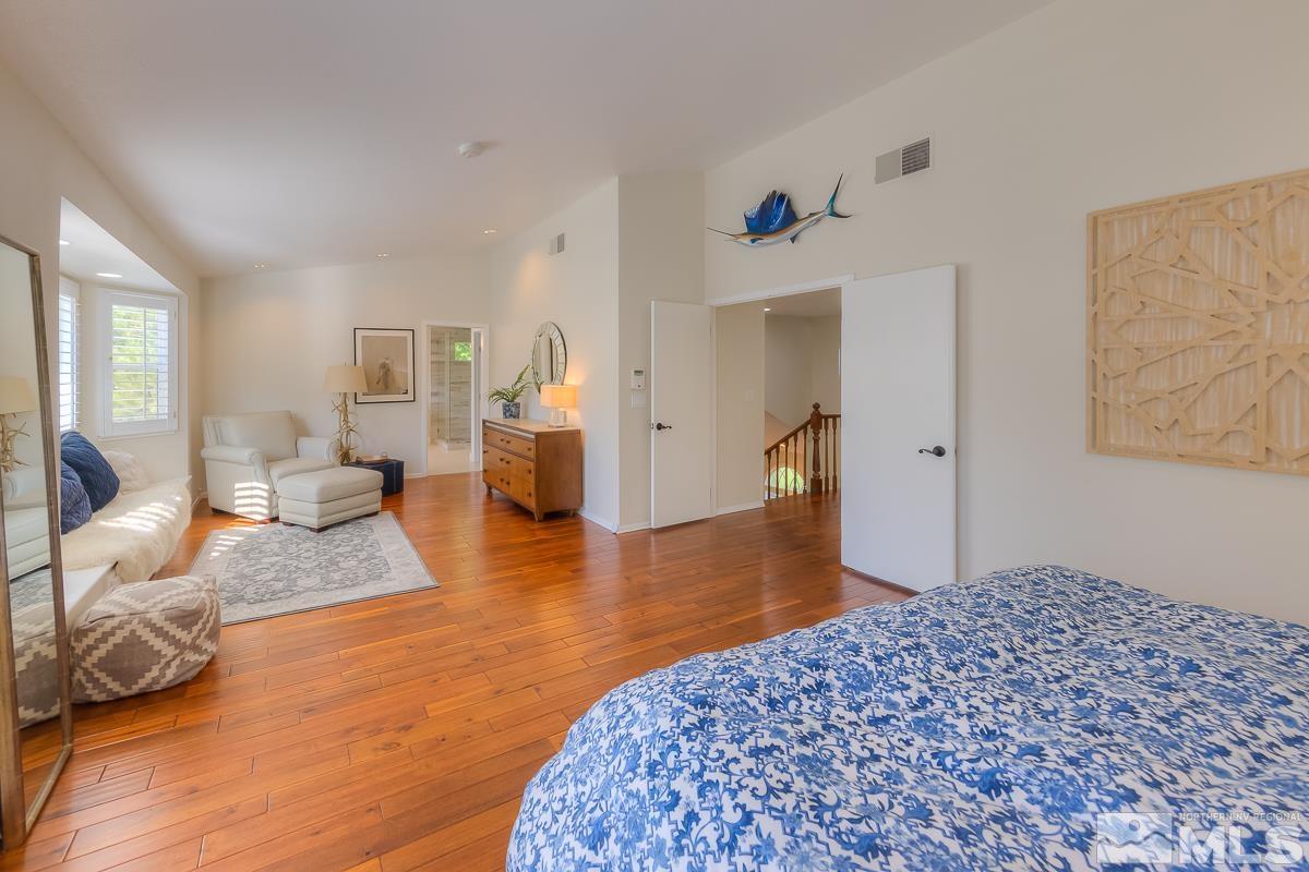 858 Lighthouse Court Reno, NV 89511 - Photo 18 of 39 a bedroom with a bed and wooden floor