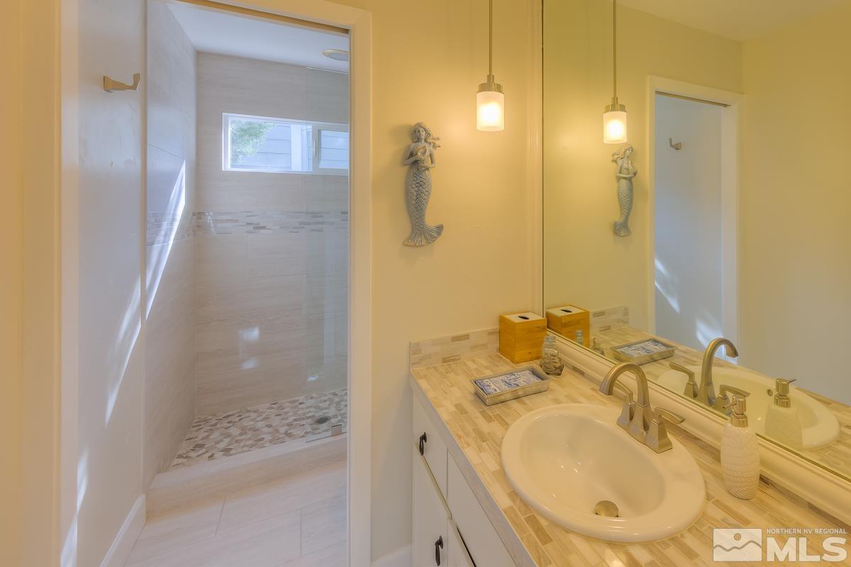 858 Lighthouse Court Reno, NV 89511 - Photo 27 of 39 a bathroom with a sink and a mirror