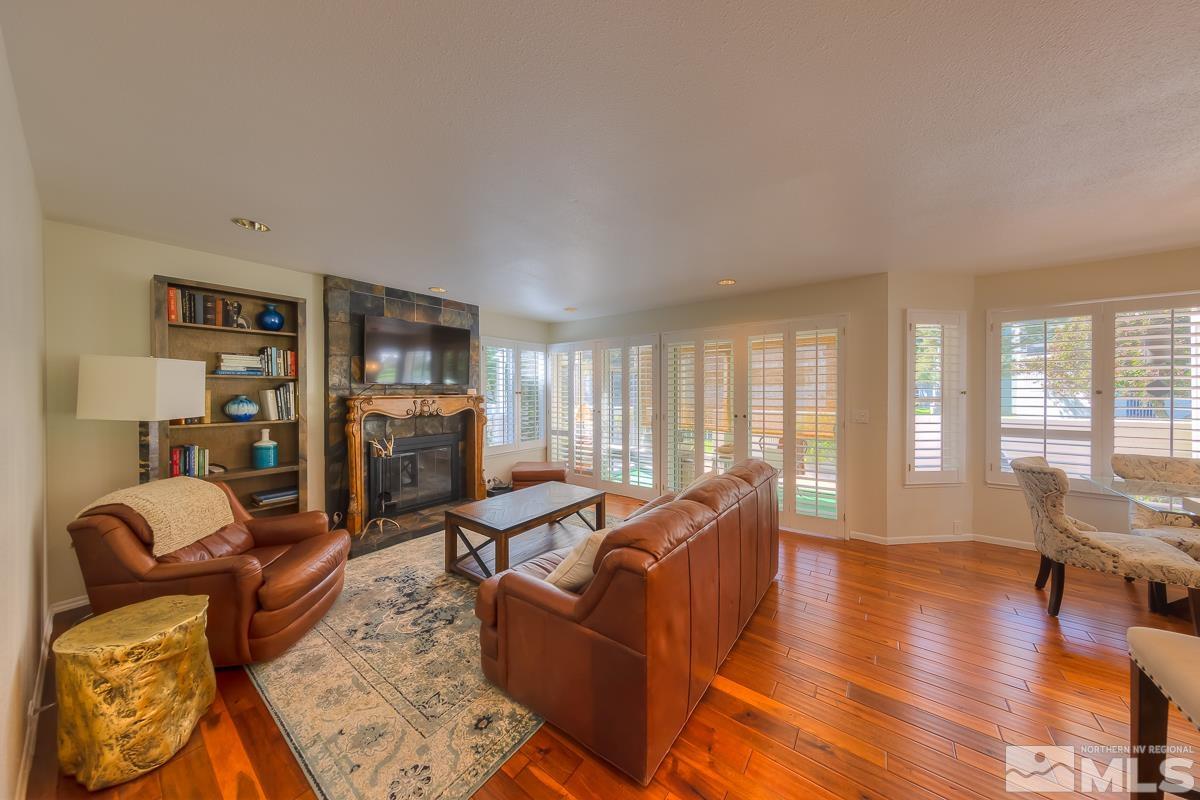858 Lighthouse Court Reno, NV 89511 - Photo 8 of 39 a living room with furniture floor to ceiling window and a flat screen tv