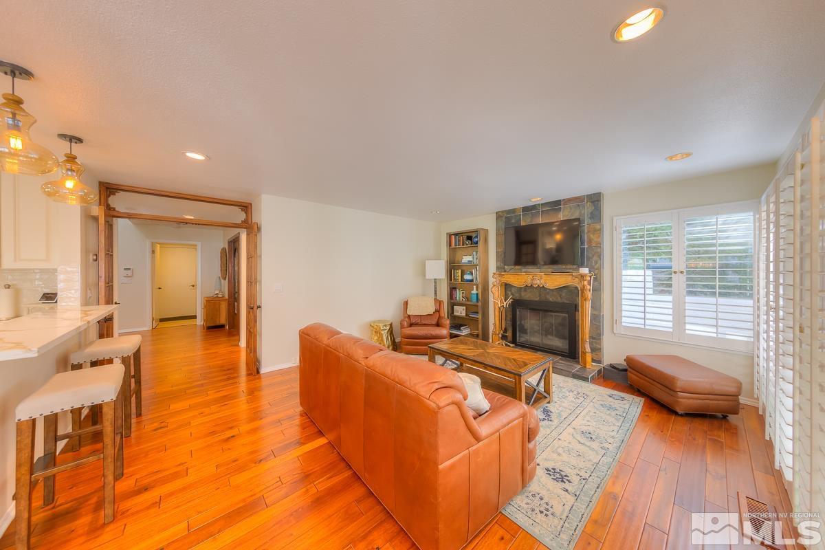 858 Lighthouse Court Reno, NV 89511 - Photo 9 of 39 a living room with furniture fireplace and a flat screen tv