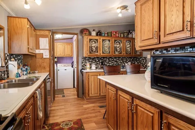 a kitchen with stainless steel appliances granite countertop a sink stove and cabinets