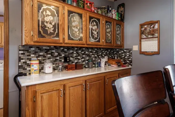 a bathroom with a granite countertop sink vanity and mirror