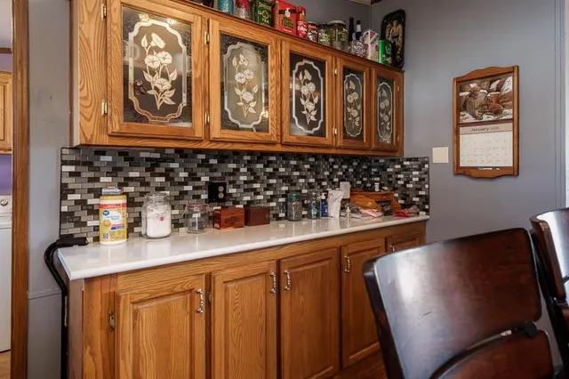 a kitchen with stainless steel appliances granite countertop a refrigerator a sink and a cabinets