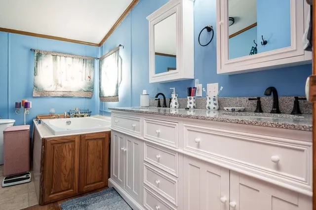 a kitchen with stainless steel appliances granite countertop a sink and cabinets with wooden floor