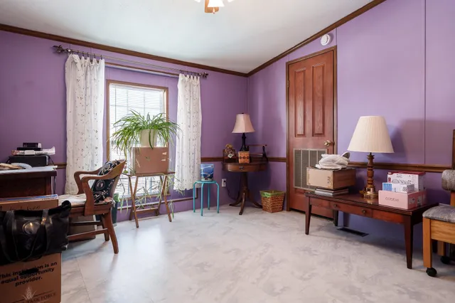 a workspace with furniture and a potted plant