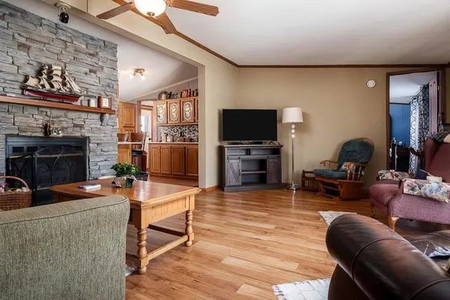 a living room with furniture a flat screen tv and a fireplace