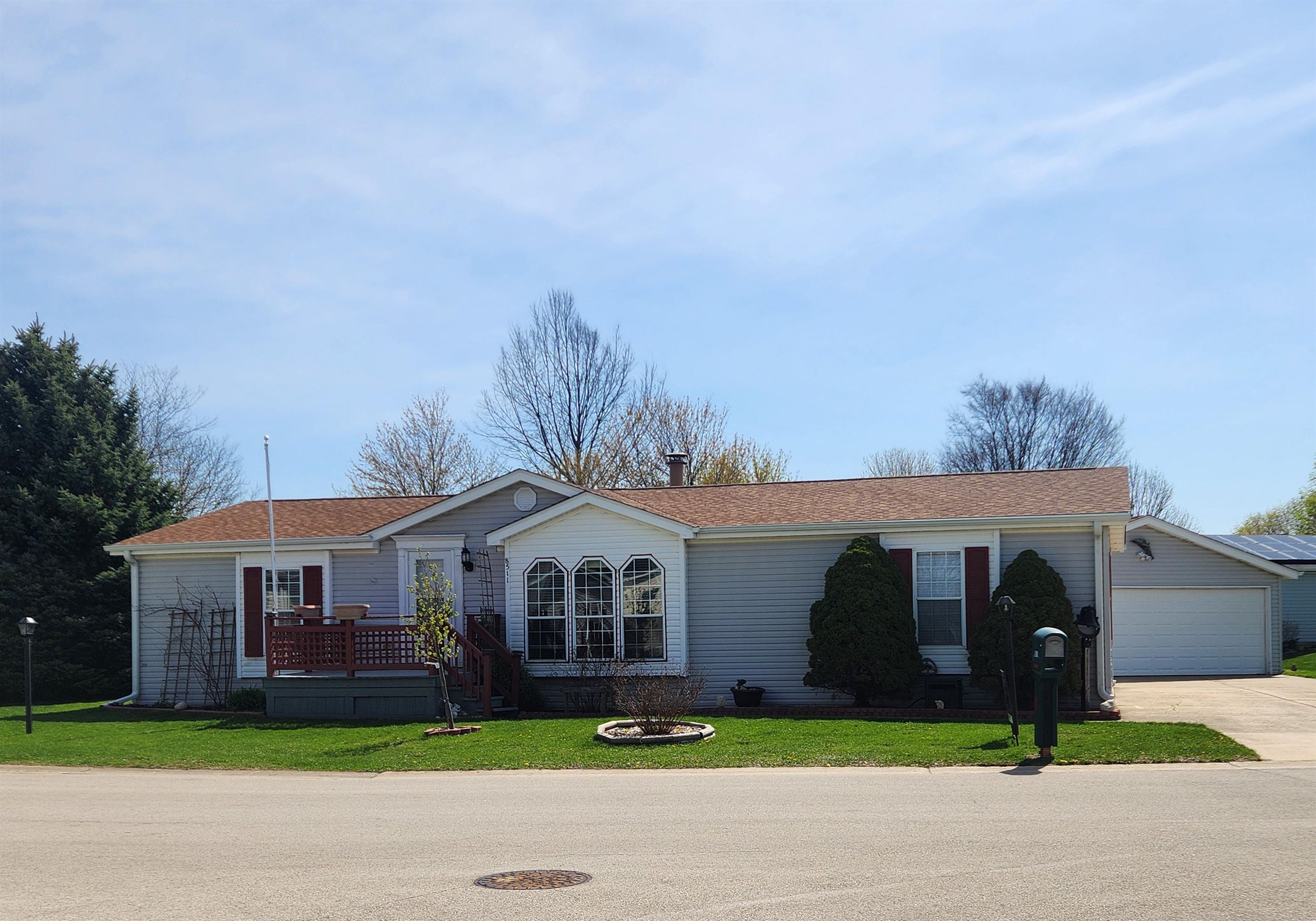 8511 Fig Tree Lane Roscoe, IL 61073 - Photo 34 of 35 a front view of a house with a garden and trees