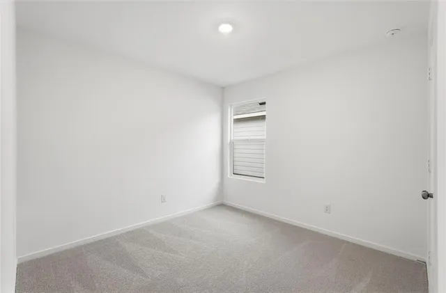 a view of an empty room and closet area