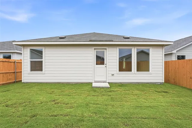 a backyard of a house with garage