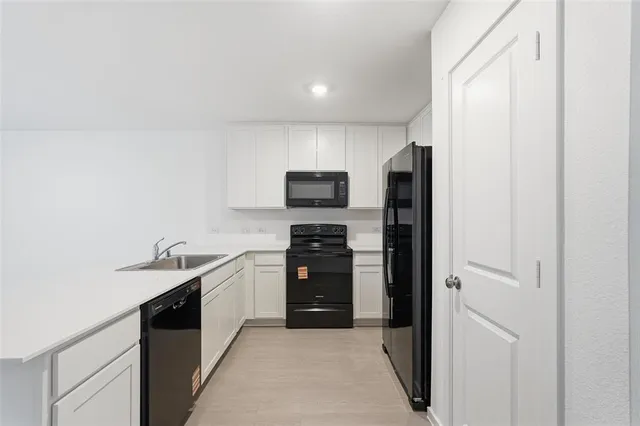 a kitchen with stainless steel appliances granite countertop a sink and stove top oven